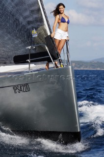 Glamorous female lifestyle model onboard a sailing yacht in the Mediterranean
