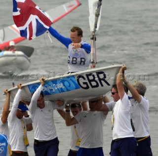 QINGDAO, CHINA - AUGUST 19: Paul Goodison of Great Britain is lifted high in his boat by team manager Stephen Park and fellow gold medalist Ben Ainslie as he celebrates overall victory in the Laser class event following the medal race held at the Qingdao Olympic Sailing Center during day 11 of the Beijing 2008 Olympic Games on August 19, 2008 in Qingdao, China.