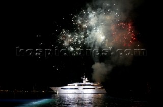 Benetti superyacht moored at anchor at night for social event