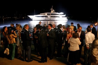 Benetti superyacht moored at anchor at night for social event