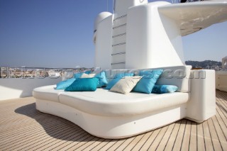 Superyacht deck sun lounger and sofa relaxation area on Emerald Star