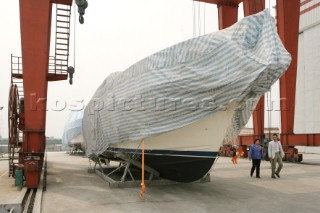 Yacht builders and skilled workers boatbuilding at the Double Happiness shipyard and boatbuilders in China