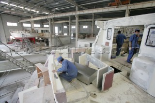 Yacht builders and skilled workers boatbuilding at the Double Happiness shipyard and boatbuilders in China