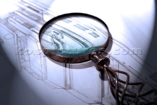 Yacht designer and naval architect Tim Heywood with magnifying glass on plans
