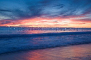 Colourful sunset over a sandy beach.