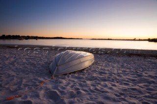 Twilight on a sandy beach with a small boat