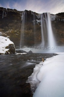 A slow of the impressive Seljalandsfoss Waterfall and icy stream, Iceland