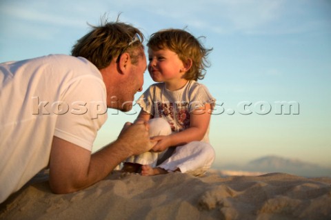 Man with his daughter on a sandy beach in Tarifa Spain near Gibraltar Model Released