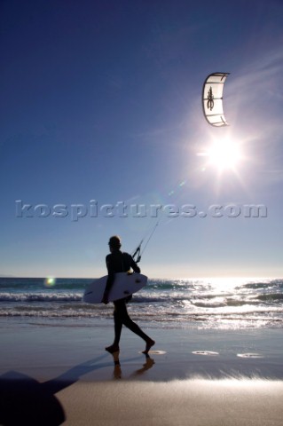 Kite surfer walking on a sandy beach in Tarifa Spain near Gibraltar