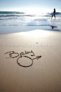 Baby boy congratulations sign writing message on a sandy beach in Tarifa, Spain, near Gibraltar.