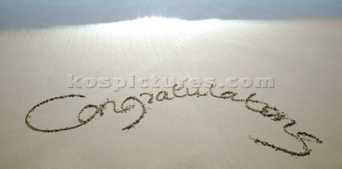 Congratulations sign writing message on a sandy beach in Tarifa Spain near Gibraltar