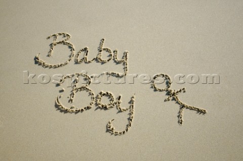 Baby boy congratulations sign writing message on a sandy beach in Tarifa Spain near Gibraltar