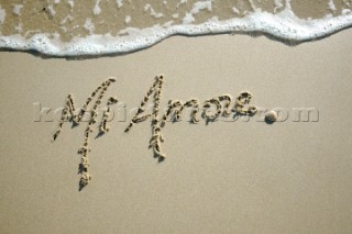 Mi Amore love romantic sign writing message on a sandy beach in Tarifa, Spain, near Gibraltar.