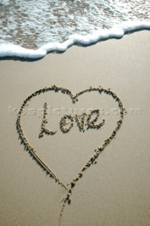 Mi Amore love romantic sign writing message on a sandy beach in Tarifa, Spain, near Gibraltar.