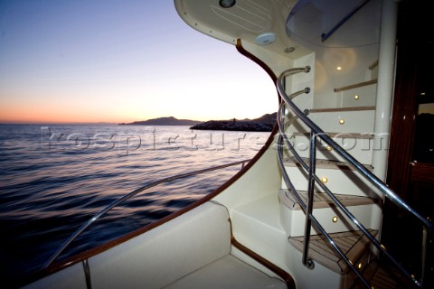 A romantic couple relaxing onboard a Vicel 72 classic motor yacht  Model Released