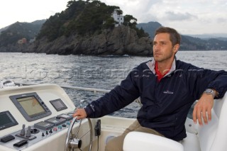 Lifestyle male man onboard a Vicem 72 classic motor yacht Model Released.
