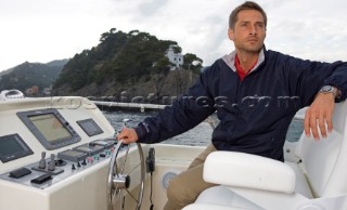 Lifestyle male man onboard a Vicem 72 classic motor yacht Model Released.