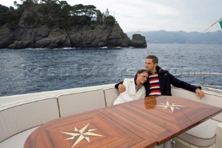 Lifestyle couple onboard a Vicem 72 classic motor yacht Model Released.