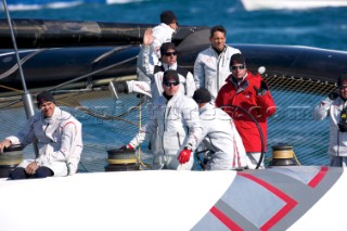 FEBRUARY 12TH 2010, VALENCIA, SPAIN: Ernesto Bertarelli (in red) on Alinghi 5 catamaran during the 1st match of the 33rd Americas Cup in Valencia, Spain.