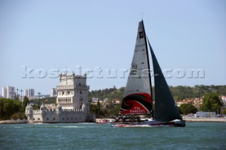 Emirates Team New Zealand pass the Torre de Belem in the river Tejo, Lisbon. The coastal race of the Trophy of Portugal, Med Cup regatta. Cascais, Portugal. 15/5/2010