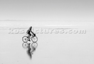 Cyclist on a deserted beach