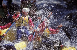 White water rafters covered in spray