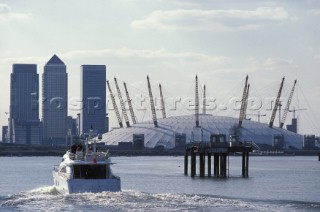 Fairline Squadron 74 heads towards the London Docklands and the Millennium Dome on the river Thames