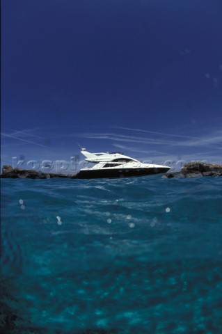 Fairline Phantom 43 at anchor in clear shallow water