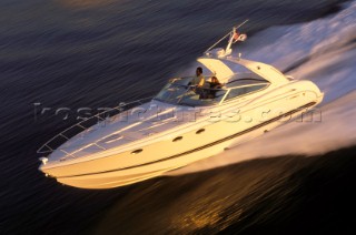 Cruising motor powerboat at speed on calm water