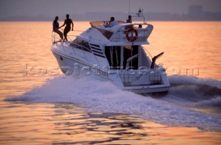Cruising motor powerboat at speed on calm water