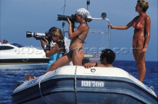 Female photographers shooting yacht racing from a RIB
