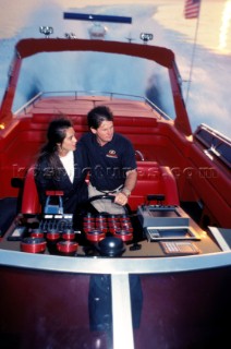 Romantic couple on a red speeding Aronow powerboat