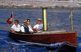 Four men in a classic wooden motor launch