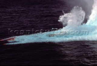 Offshore Class 1 powerboat crashing and nose diving into a wave at high speed, totally submerged underwater