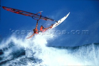 Windsurfer flying from a breaking wave on the surf line