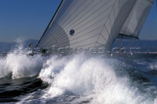 Bow of maxi yacht with North Sails logo in crashing wave