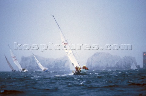 Yachts racing towards The Needles off the Isle of Wight in stormy conditions