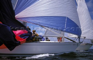 Crew change spinnaker during racing on board swan yacht