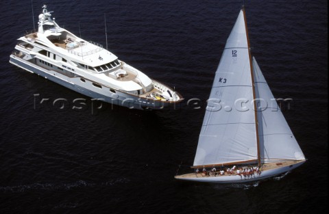 12m Tomahawk sailing passed anchored superyacht