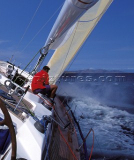 Crew to leeward trimming the 3DL jib onboard the Swan 60 Highland Fling racing upwind