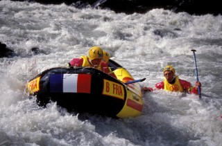 Man falling from inflatable raft whilst White Water Rafting