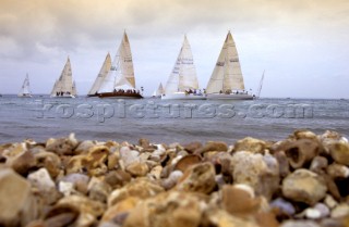 Yachts racing off a pebble beach