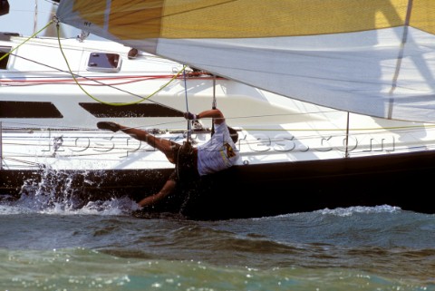 Crew member falling over side of racing yacht