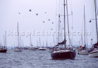 Naval helicopters fly above an anchored fleet of spectators at the Trafalgar 200 celebrations 2005