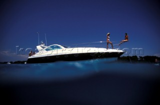 Male and female models relaxing and socialising on a luxury Fairline powerboat