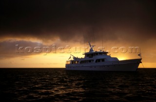 Superyacht Antilles in the sunset before a storm