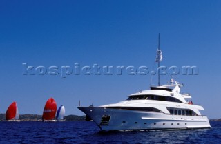 Superyacht My Way with 30ft racing yacht on the top deck passing by colourful red spinnakers