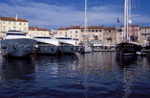 Line of moored superyachts and maxi sailing yachts in the port of St Tropez France