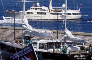 Motor superyacht passes by Wally maxi Wallygator moored against the harbour wall in St Tropez
