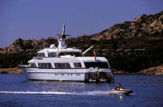 Cruising superyacht at anchor in a quiet anchorage mooring
